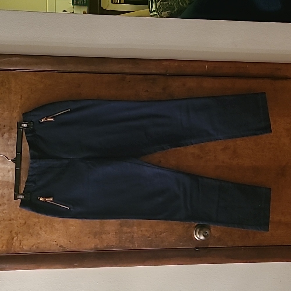 blue trousers with gold zippered pockets